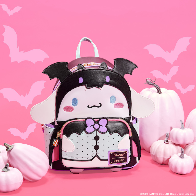 Mini backpack of Sanrio Cinnamoroll dressed as a vampire bat for Halloween against a pink background with pink pumpkins and bats